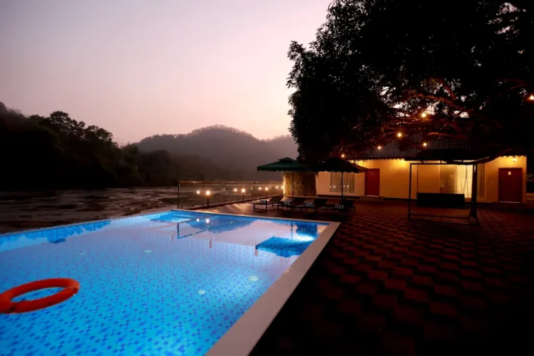 KANOVA Resort infinity pool overlooking Chalakudy River at night in Athirappilly